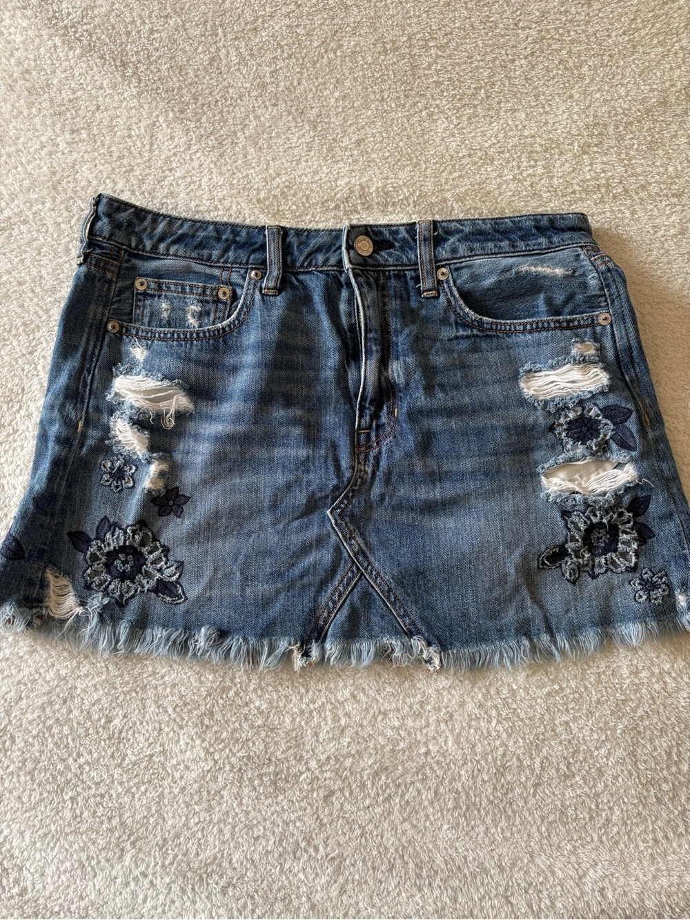 American Eagle Women’s Blue Distressed Denim Mini Skirt with Floral Embroidery